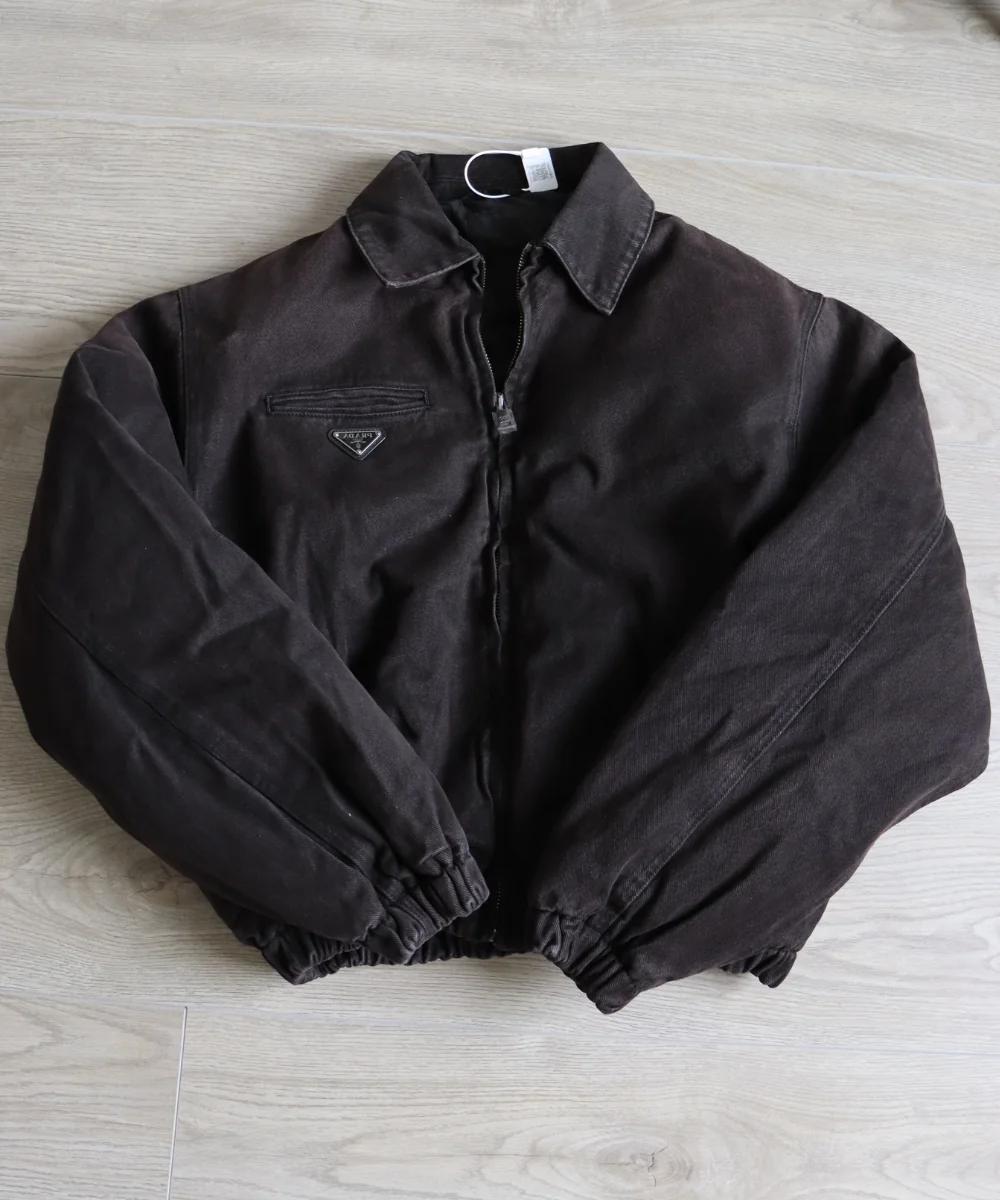 Dark cropped bomber jacket laid flat