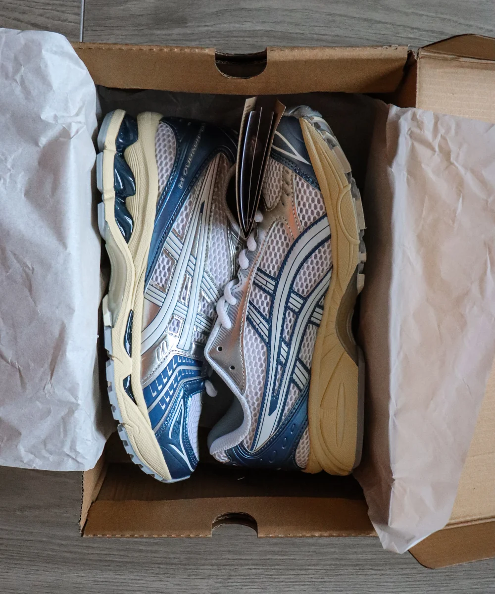 Cream and metallic blue Gel-Kayano 14-style sneakers in their box