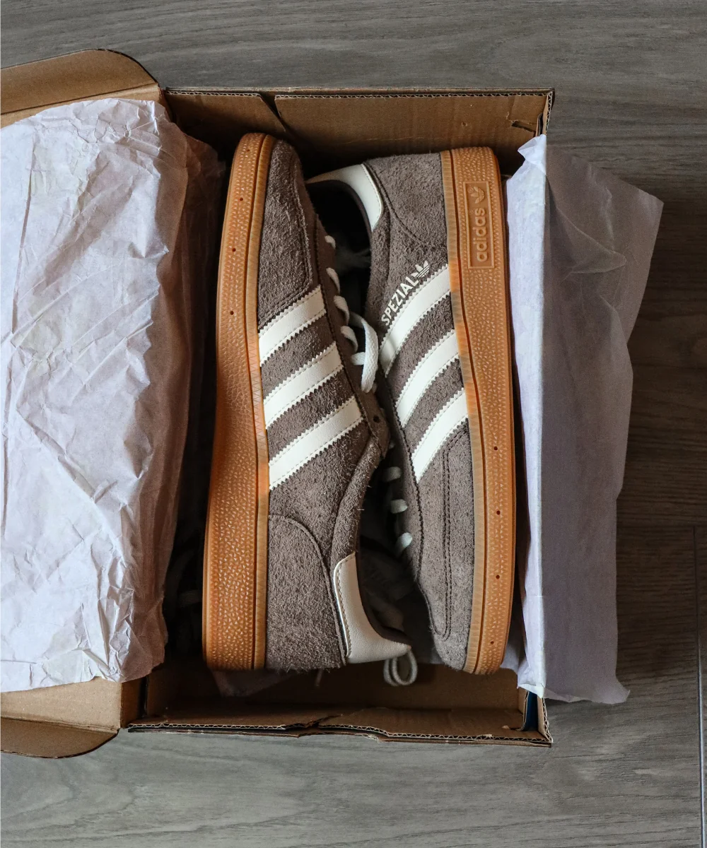 Brown Adidas Spezial-style trainers in their box