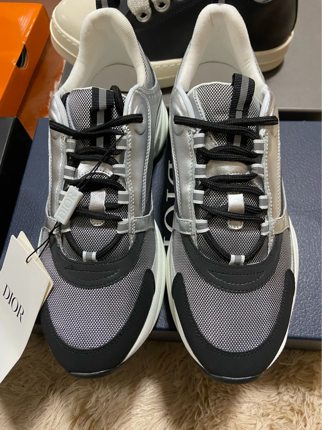 Grey B22-style sneakers with black laces — front view