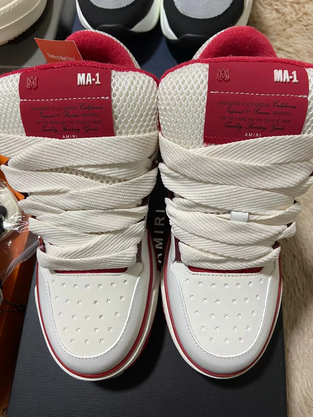 Red and white AMIRI-labelled sneakers — front view from a Fishgoo shoe haul