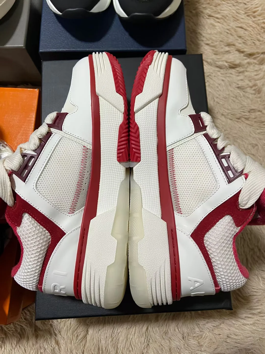 Red and white AMIRI-labelled sneakers — side profile
