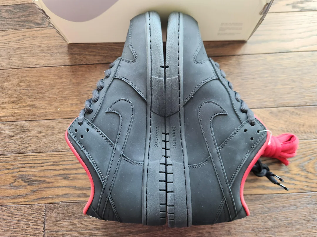 Black and red Supreme-style SB sneakers — side view