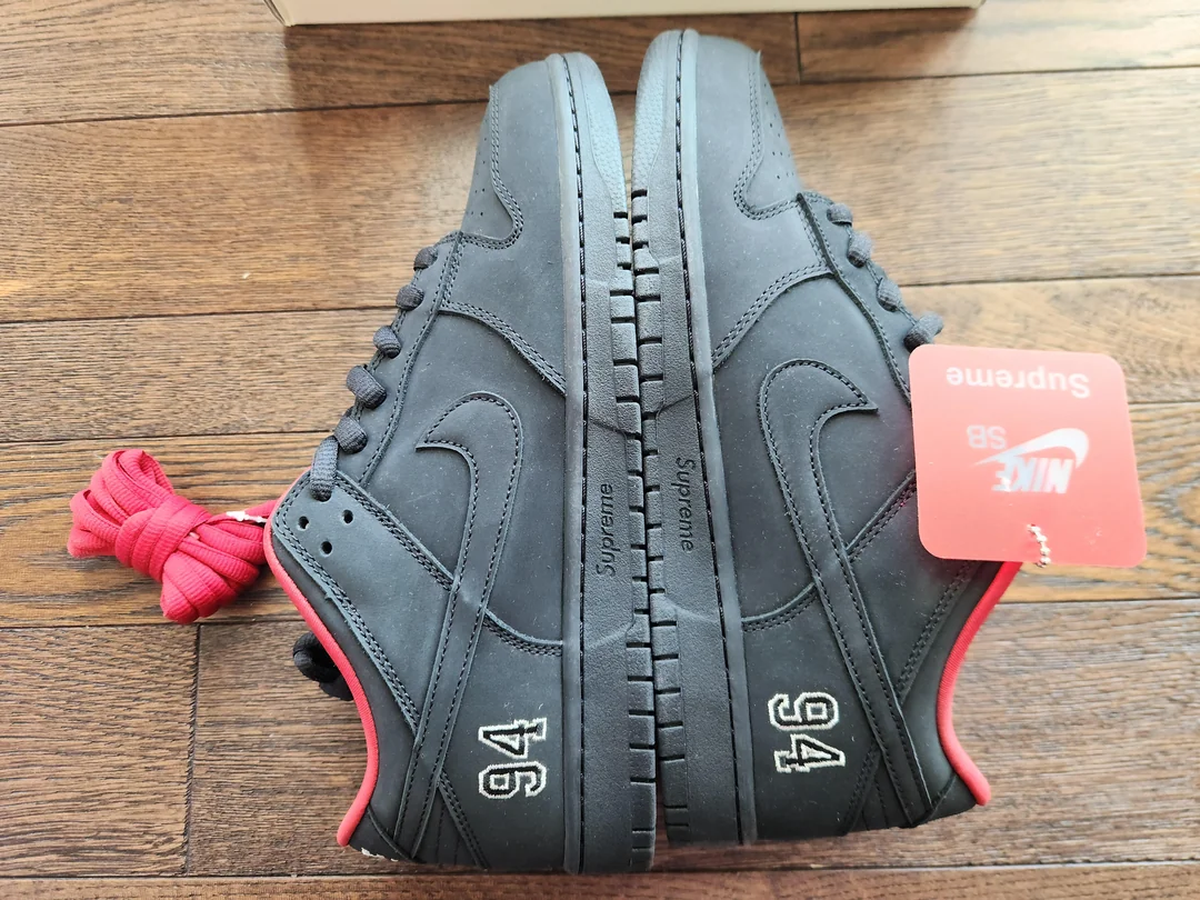 Black and red SB sneakers — paired side view