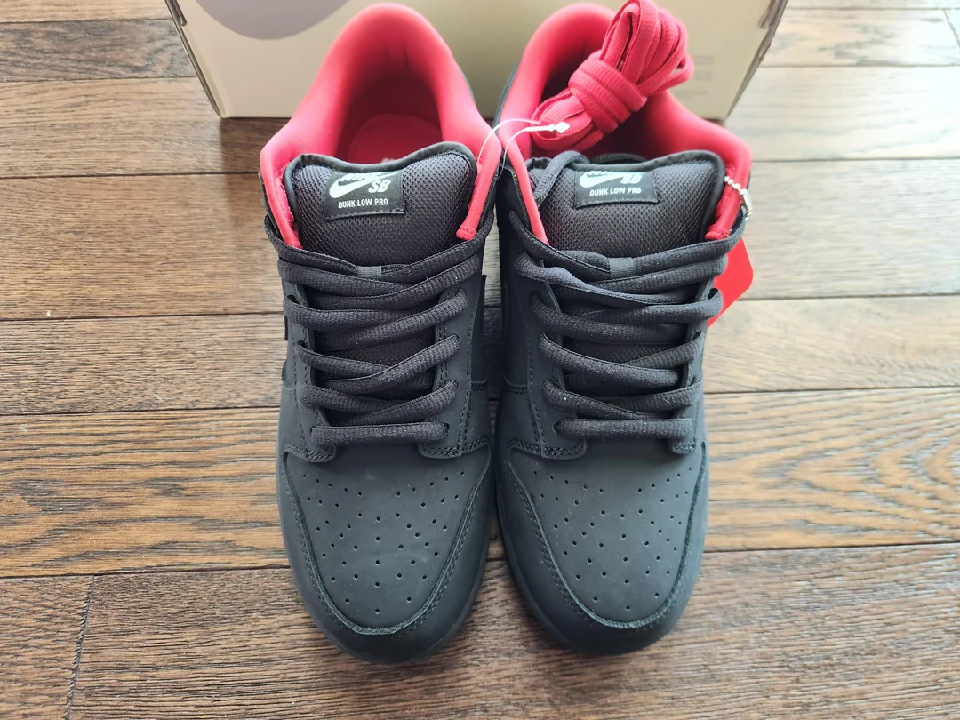 Black and red SB sneakers — front view